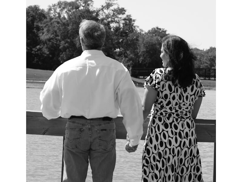 Marina and Her Husband Holding Hands in Front of Lake